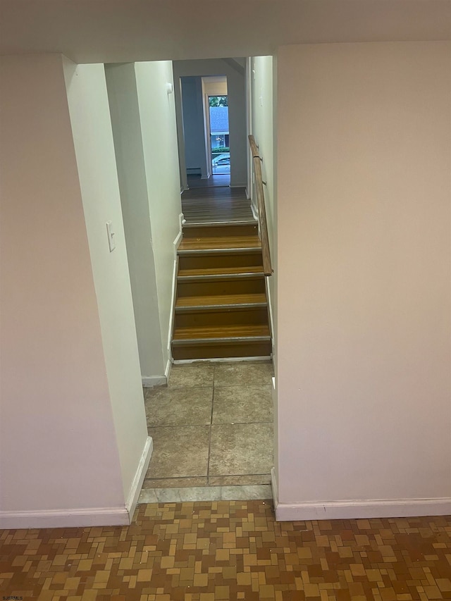 stairway featuring concrete floors