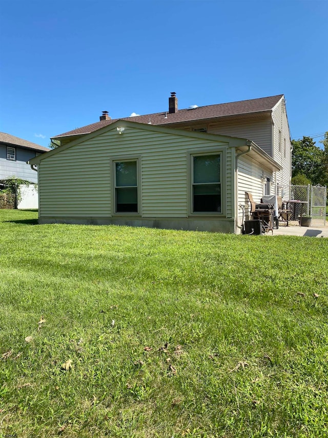 rear view of property with a yard and a patio