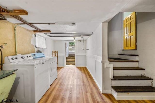 clothes washing area featuring independent washer and dryer and light wood-type flooring