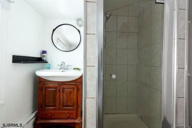 bathroom with a shower with door and vanity