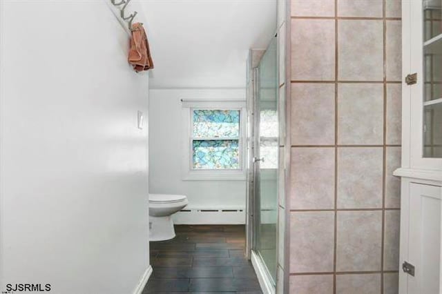 bathroom featuring baseboard heating, toilet, an enclosed shower, and hardwood / wood-style flooring