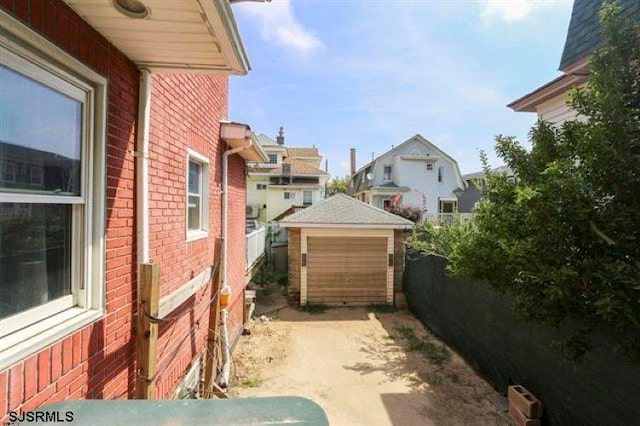 view of side of home with a garage and an outdoor structure