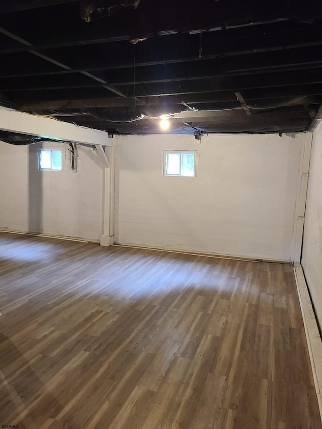 basement with hardwood / wood-style floors