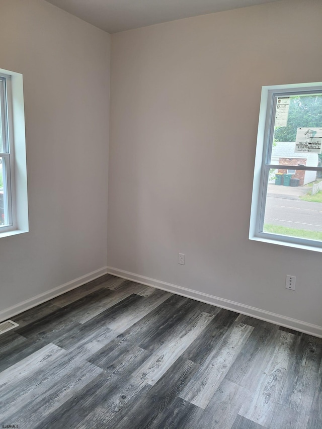 empty room with dark wood-type flooring