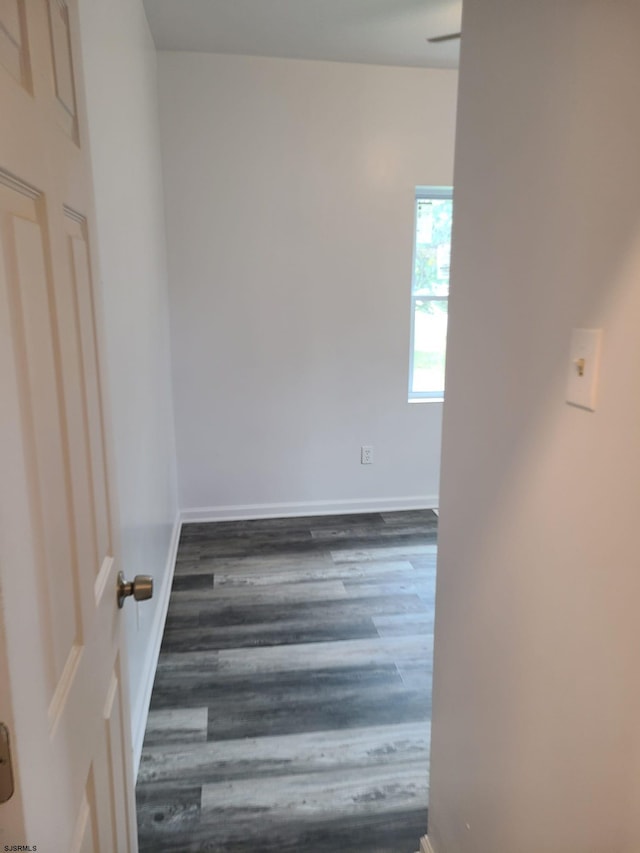 unfurnished room with dark hardwood / wood-style floors