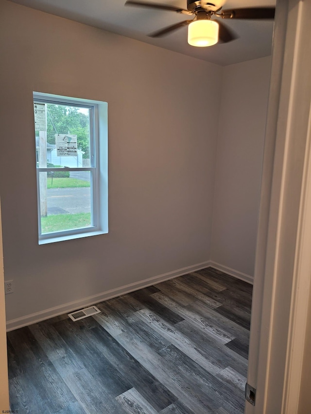 unfurnished room featuring ceiling fan and dark hardwood / wood-style flooring