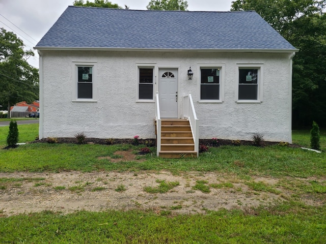 bungalow-style home with a front lawn