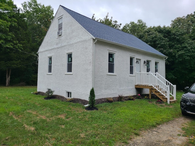 view of front of property with cooling unit and a front yard