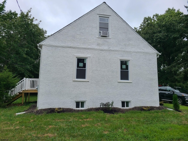 view of property exterior featuring a yard and a deck