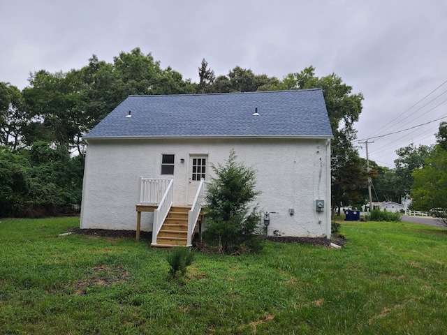 back of property with a lawn