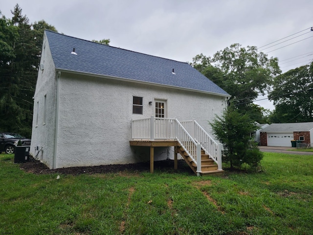 back of house with a yard and a garage