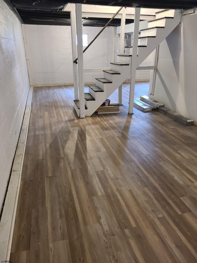 basement with dark hardwood / wood-style floors