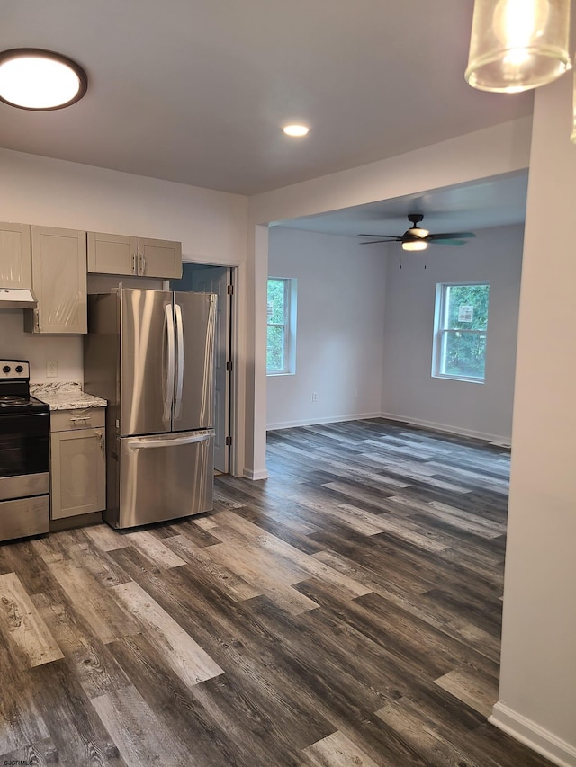 kitchen featuring light stone countertops, dark wood-type flooring, stainless steel appliances, gray cabinets, and ceiling fan