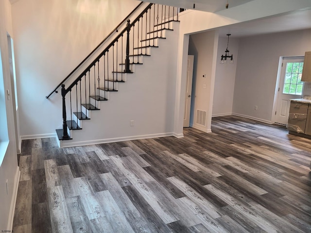 interior space featuring an inviting chandelier and dark hardwood / wood-style flooring