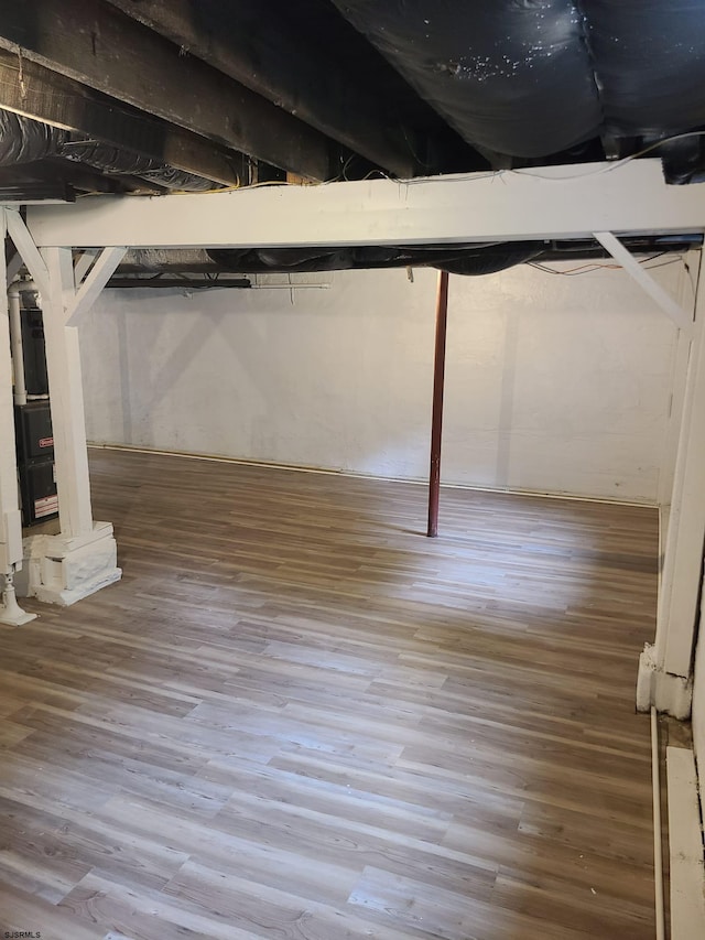 basement with hardwood / wood-style floors