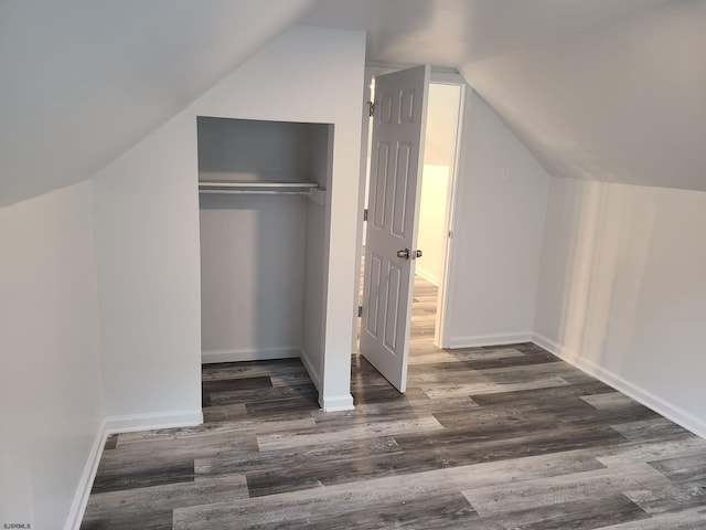 additional living space featuring dark hardwood / wood-style floors and vaulted ceiling