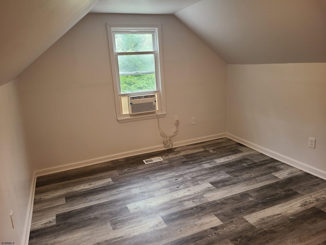 bonus room featuring dark wood-type flooring, cooling unit, and vaulted ceiling