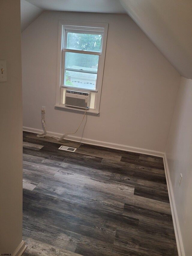 bonus room with lofted ceiling, cooling unit, and dark hardwood / wood-style flooring