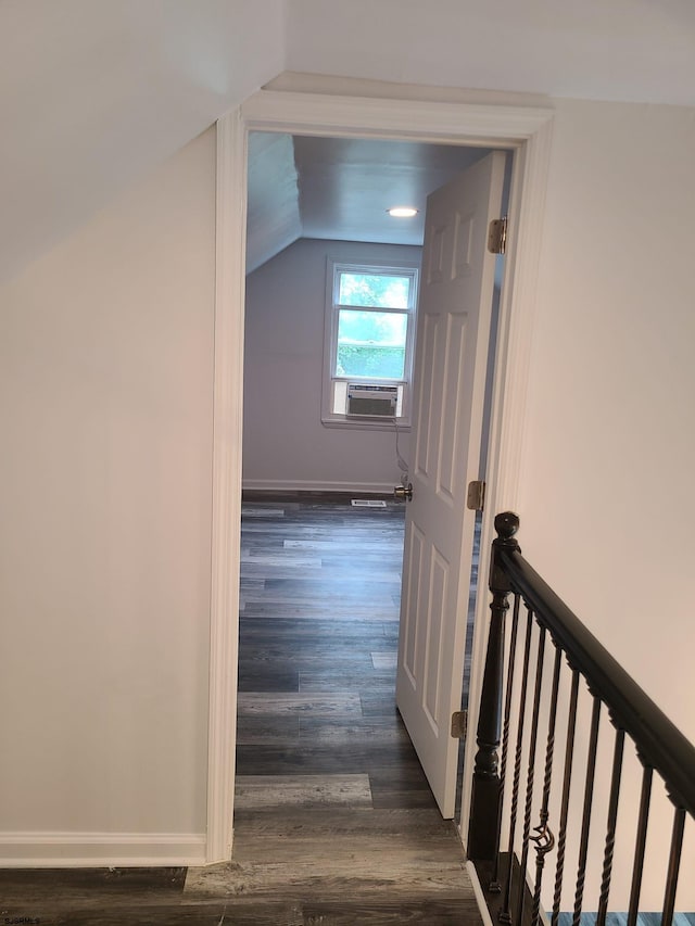 hall with cooling unit, vaulted ceiling, and dark hardwood / wood-style flooring