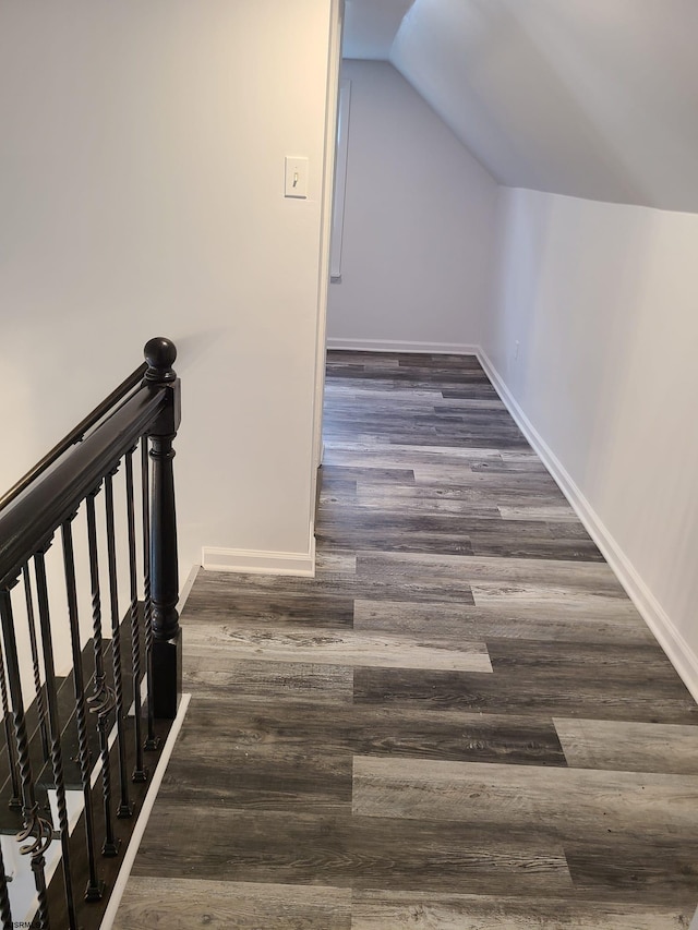 interior space featuring vaulted ceiling and dark hardwood / wood-style flooring