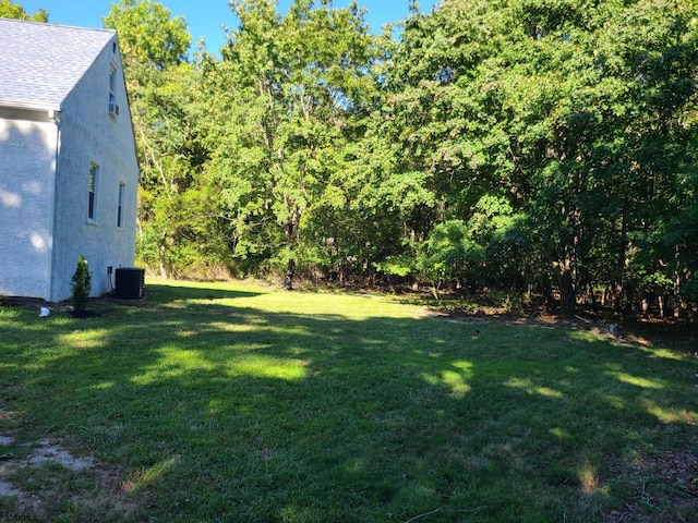 view of yard featuring central air condition unit