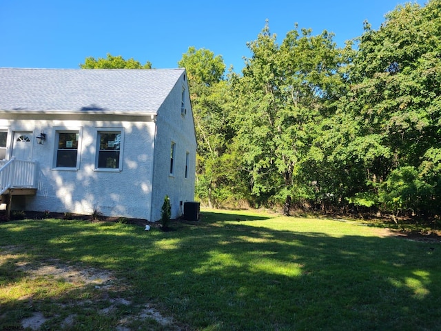 view of property exterior featuring cooling unit and a yard