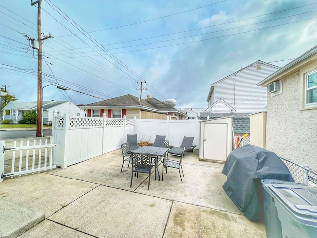 view of patio / terrace with grilling area and a storage unit