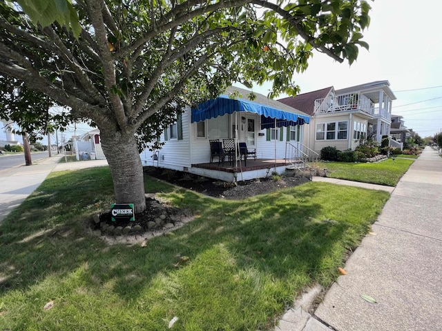 view of front of house with a front yard and a porch