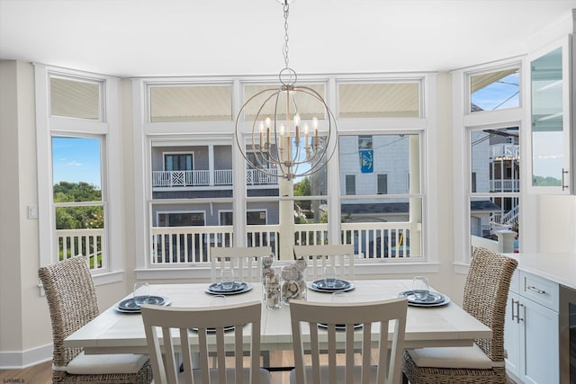 dining area with an inviting chandelier and hardwood / wood-style floors