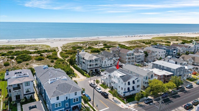 birds eye view of property featuring a water view and a view of the beach