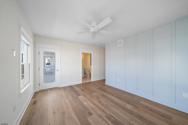 empty room with light hardwood / wood-style flooring and ceiling fan