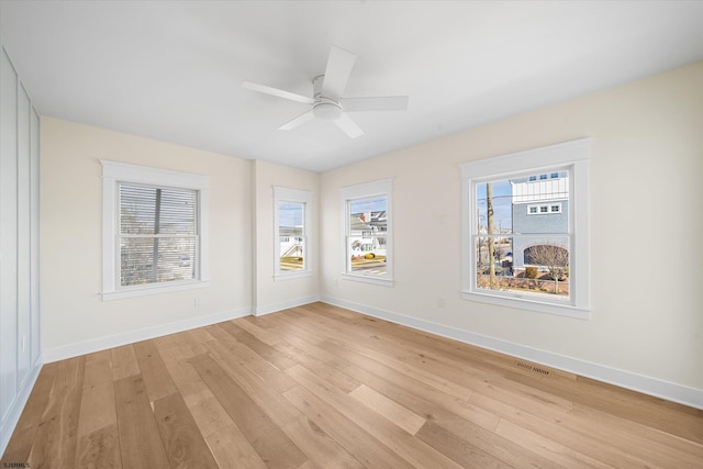 spare room with ceiling fan and light hardwood / wood-style floors