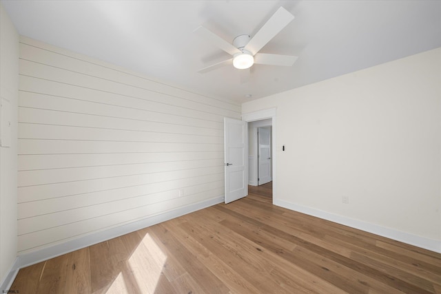 spare room featuring ceiling fan and light hardwood / wood-style floors