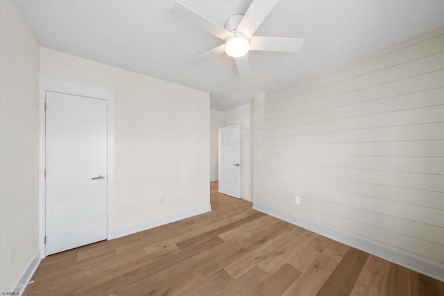 spare room featuring ceiling fan and light hardwood / wood-style floors