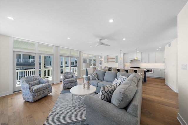 living room with a healthy amount of sunlight, hardwood / wood-style floors, and ceiling fan