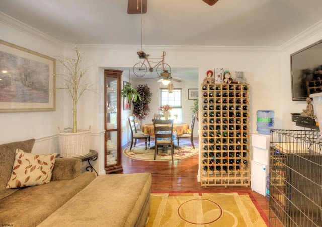 interior space with hardwood / wood-style floors, ceiling fan, and crown molding