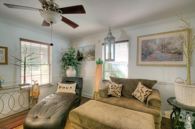 living room with ornamental molding, a healthy amount of sunlight, wood-type flooring, and ceiling fan