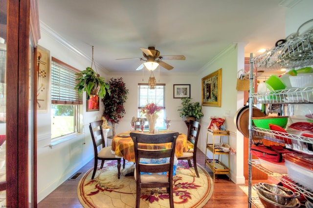 dining area with ceiling fan, dark hardwood / wood-style flooring, and ornamental molding