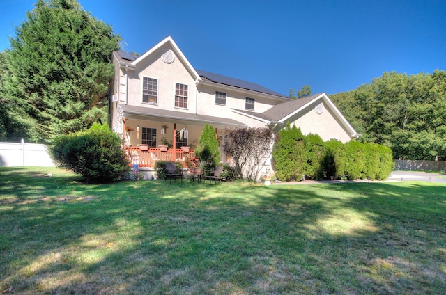 view of front facade featuring covered porch and a front yard