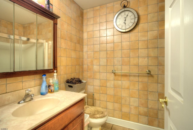 bathroom featuring vanity, toilet, tile walls, and tile patterned floors