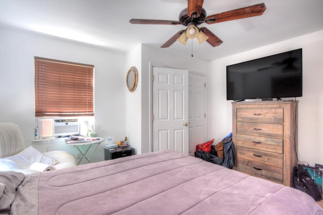 bedroom featuring cooling unit and ceiling fan