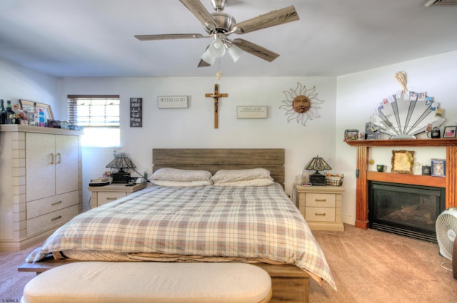 bedroom with ceiling fan and light carpet