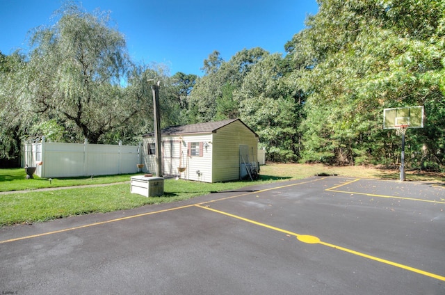 view of parking with a yard and basketball court