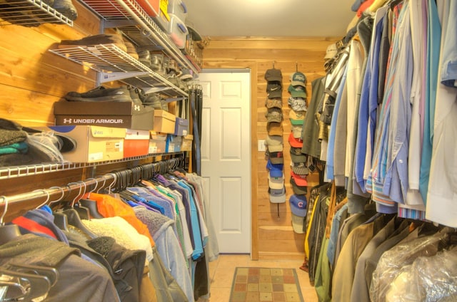 walk in closet with light tile patterned floors