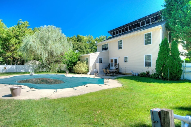 view of pool with a lawn and a patio