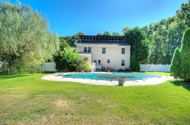 view of swimming pool featuring a lawn and a patio