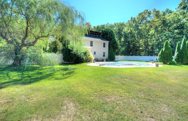 view of yard featuring a fenced in pool and a patio