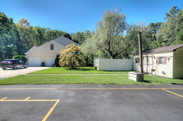 exterior space featuring a lawn and a garage