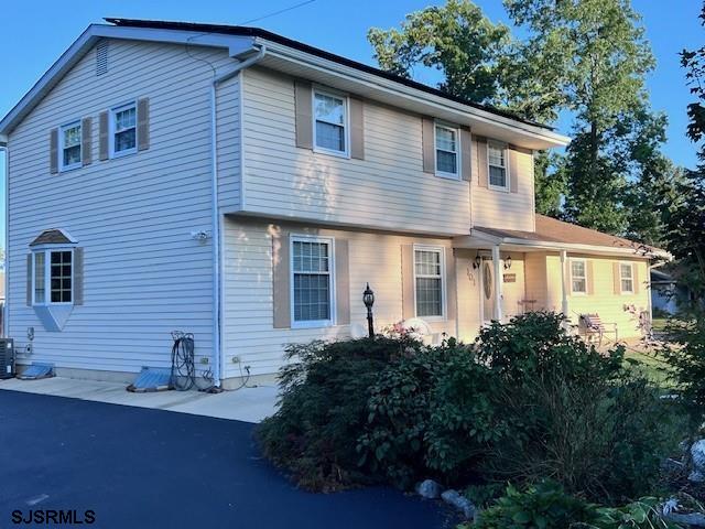 view of front of home featuring cooling unit