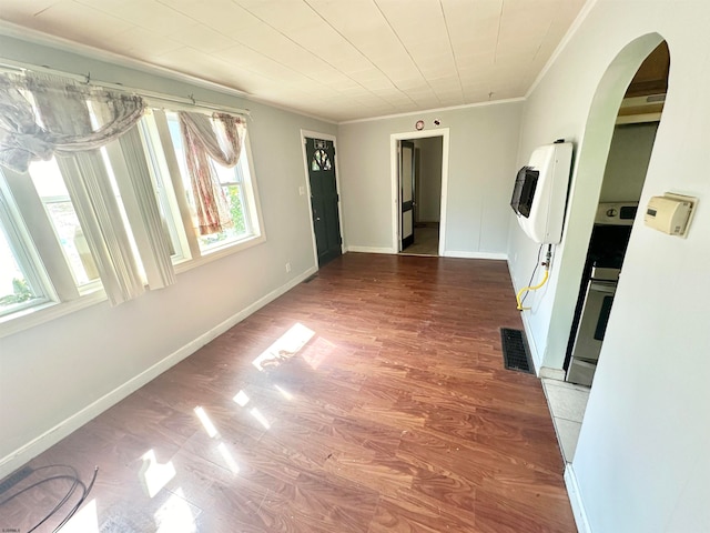 interior space featuring a wealth of natural light, hardwood / wood-style flooring, and heating unit